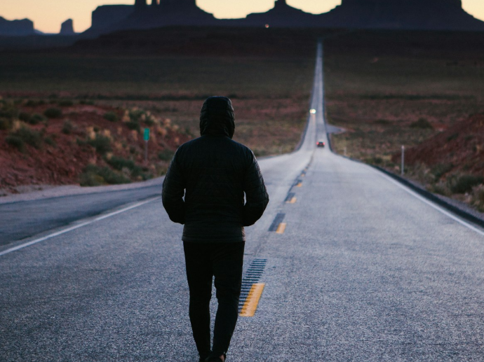 person walking in the center of the road